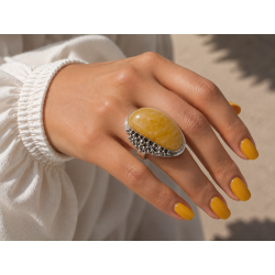 Unique ring with elongated amber and exceptional silver bead sett